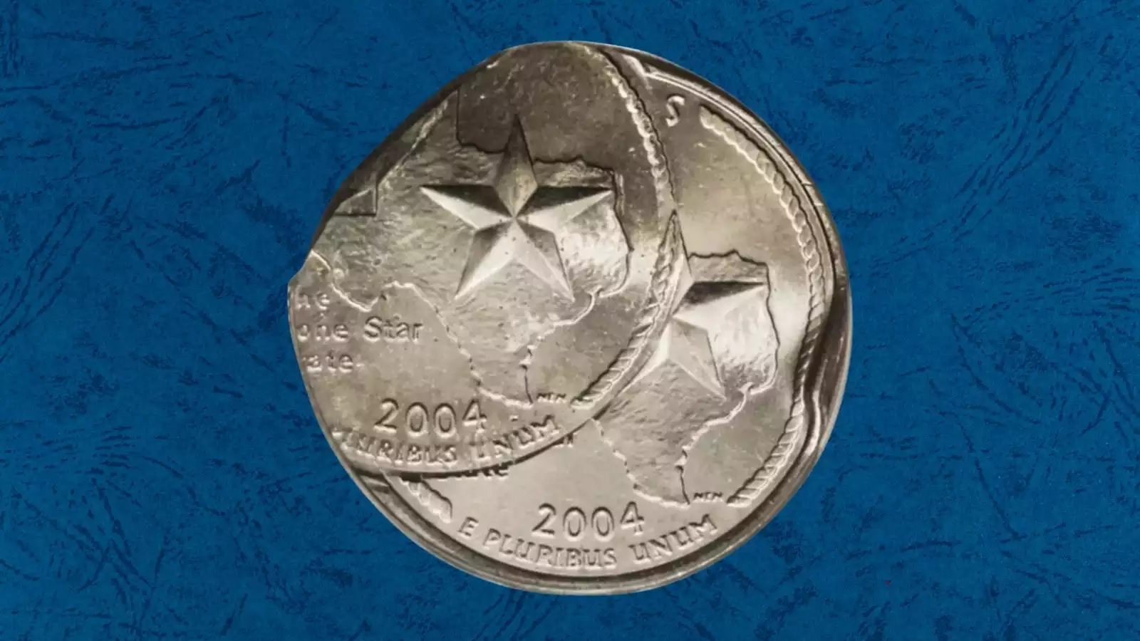 2004 State Quarter die clash error — ghost imagery from opposing die transferred to coin surface